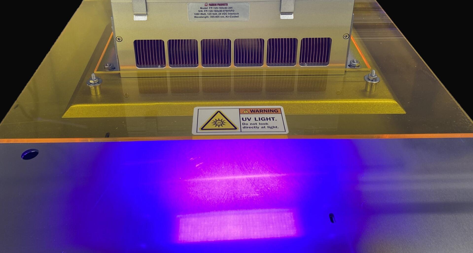view of Fannon's UV LED Curing System with the UV lights reflecting off of a surface